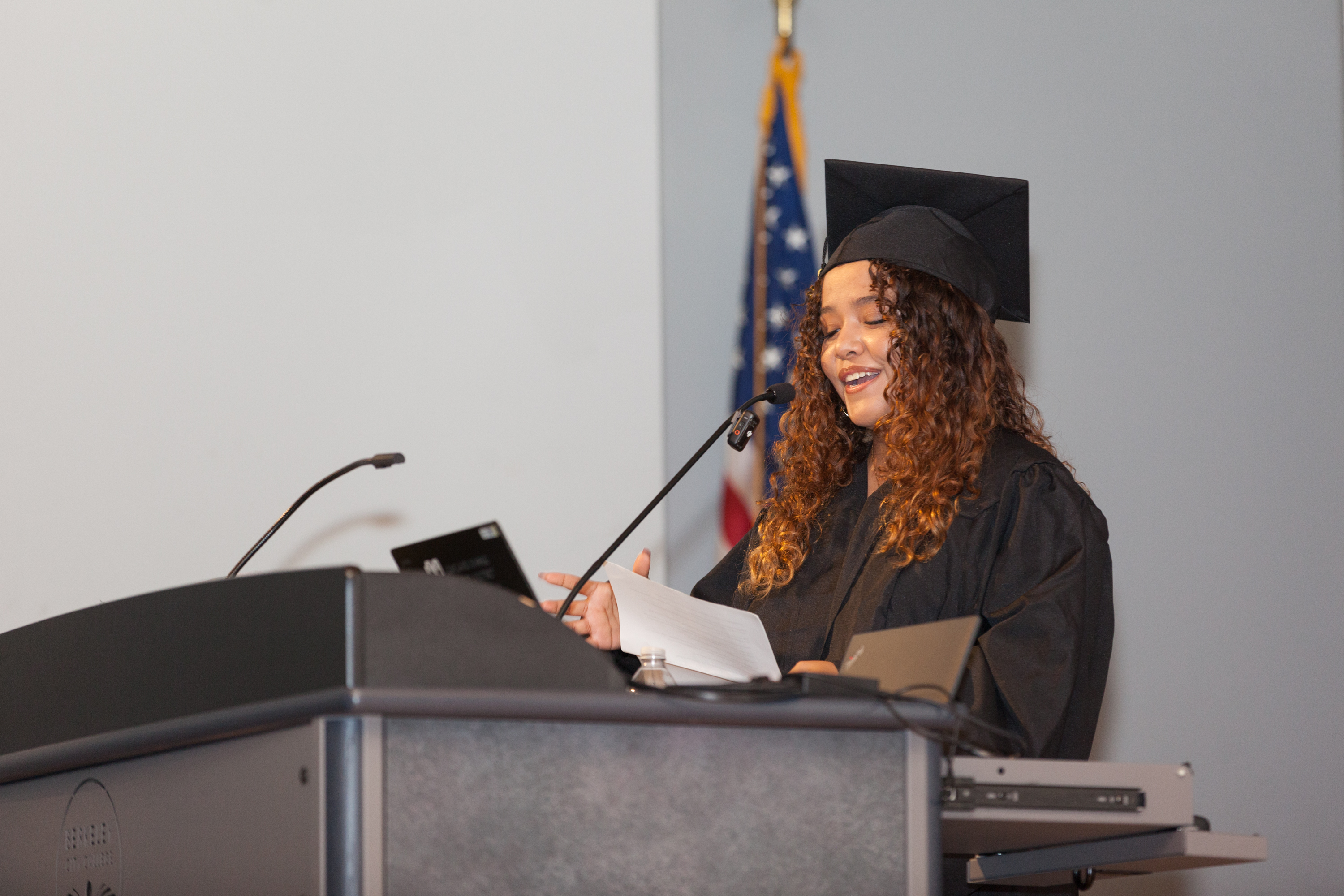 OakTown Leaders graduate speaking at a podium